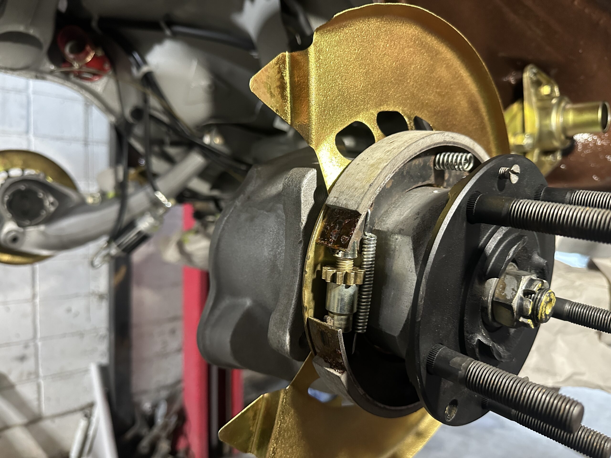 The center hub has been thoroughly cleaned, painted, and is now free of rust, ready to receive the brake disc for installation."